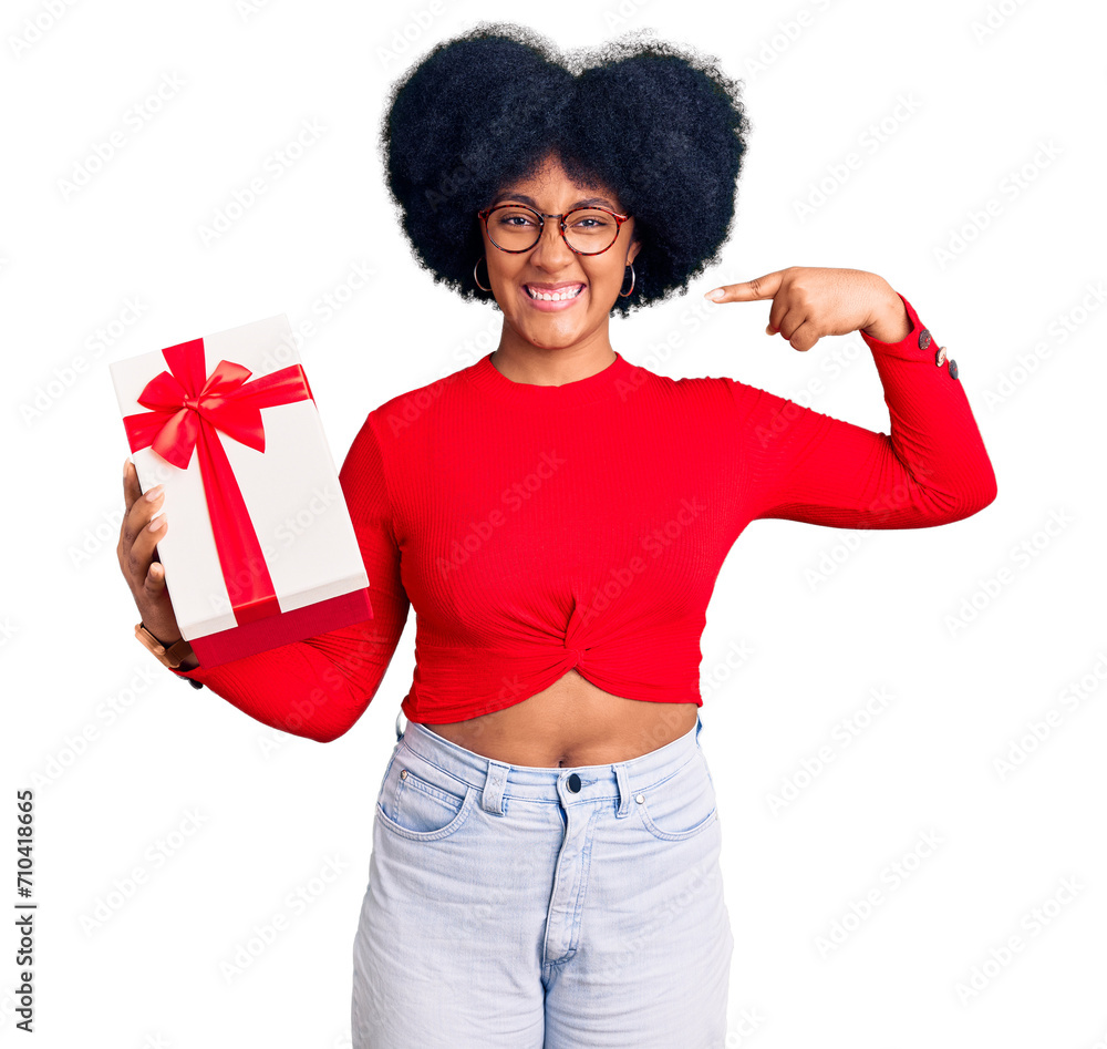 Young african american girl holding gift smiling cheerful showing and pointing with fingers teeth and mouth. dental health concept. Young african american girl holding gift smiling cheerful showing and pointing with fingers teeth and mouth. dental health concept.