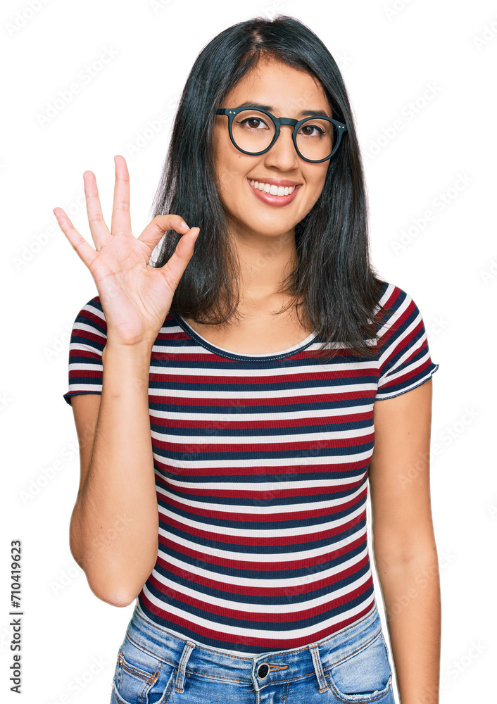 Beautiful asian young woman wearing casual clothes and glasses smiling positive doing ok sign with hand and fingers. successful expression. Beautiful asian young woman wearing casual clothes and glasses smiling positive doing ok sign with hand and fingers. successful expression.