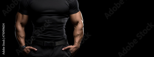 Torso of an athletic muscular man in casual clothes on a black background. Security service or bodyguard advertising banner layout. © OleksandrZastrozhnov