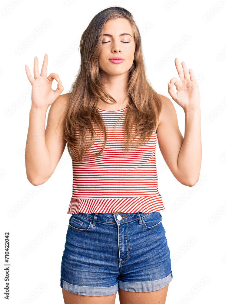 Beautiful caucasian young woman wearing casual clothes relax and smiling with eyes closed doing meditation gesture with fingers. yoga concept. Beautiful caucasian young woman wearing casual clothes relax and smiling with eyes closed doing meditation gesture with fingers. yoga concept.