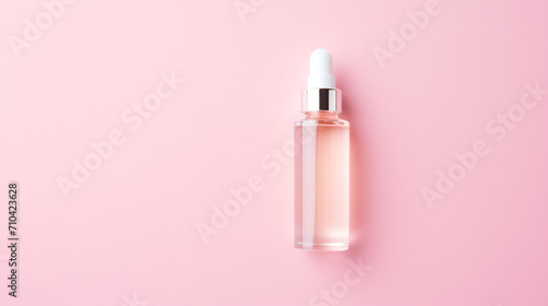 Cosmetic serum on pink background top view. Space photo