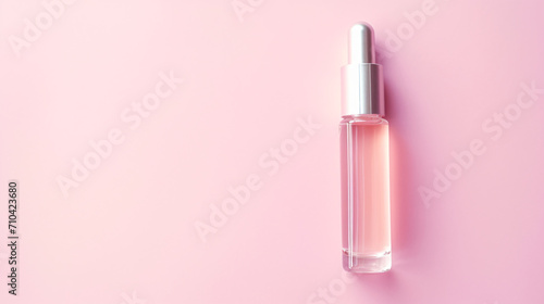 Cosmetic serum on pink background top view. Space