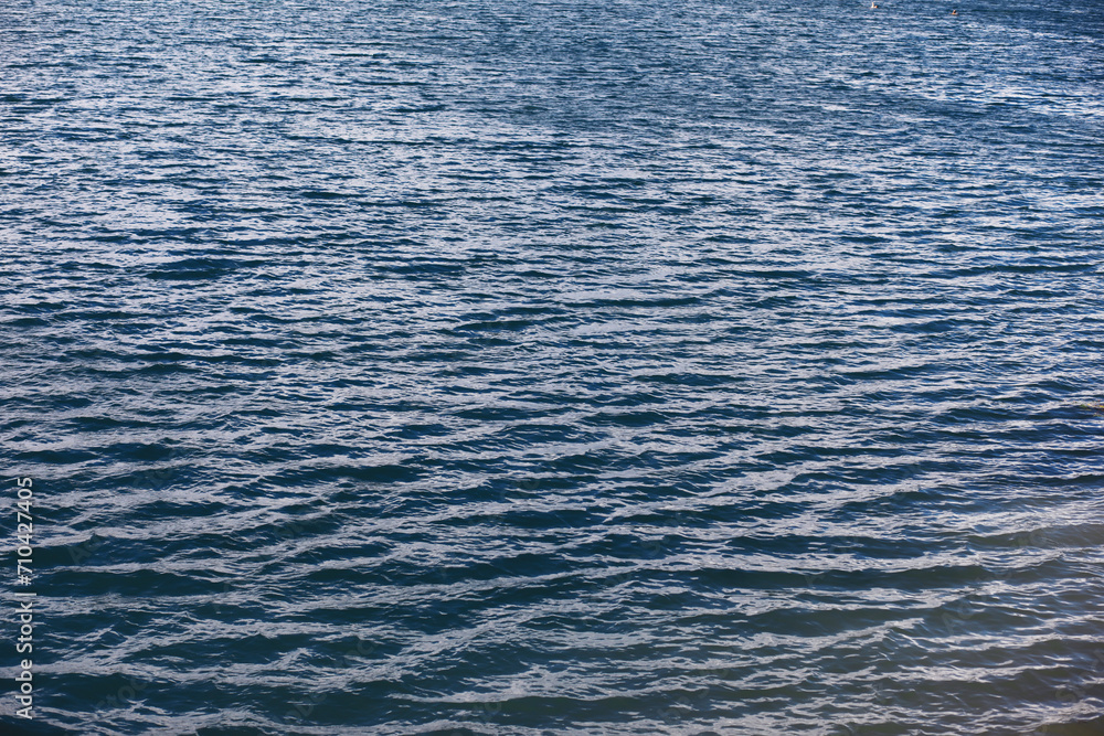 Water surface. The texture of the water. Waves on the lake in windy weather. Water surface. The texture of the water. Waves on the lake in windy weather.
