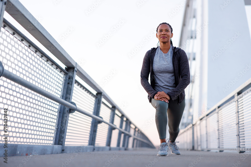 Woman stretching out before morning workout Woman stretching out before morning workout