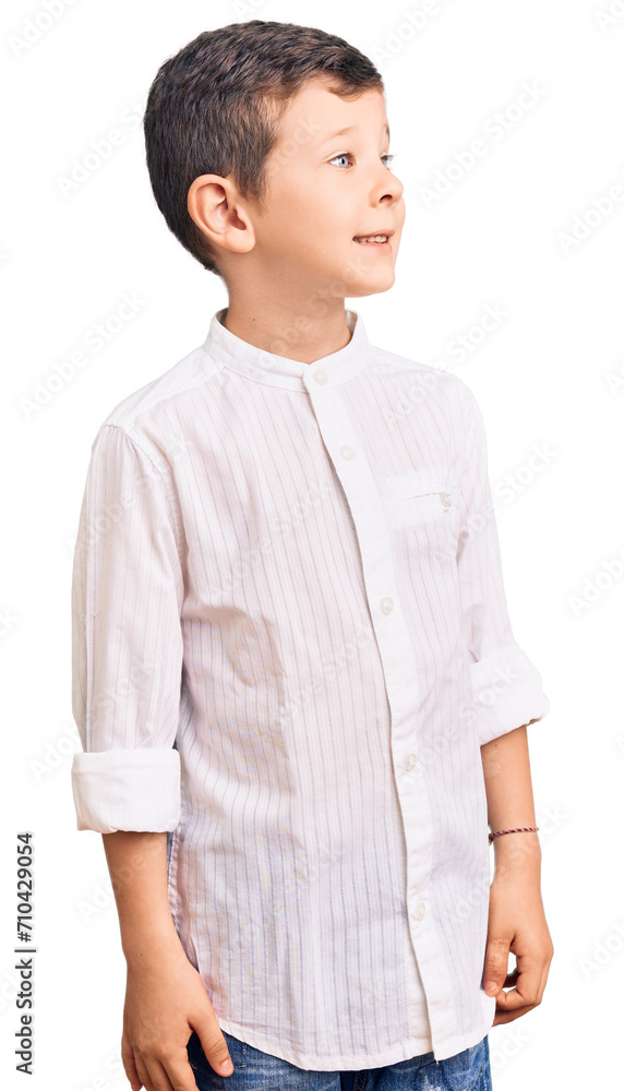 Cute blond kid wearing elegant shirt looking away to side with smile on face, natural expression. laughing confident. Cute blond kid wearing elegant shirt looking away to side with smile on face, natural expression. laughing confident.