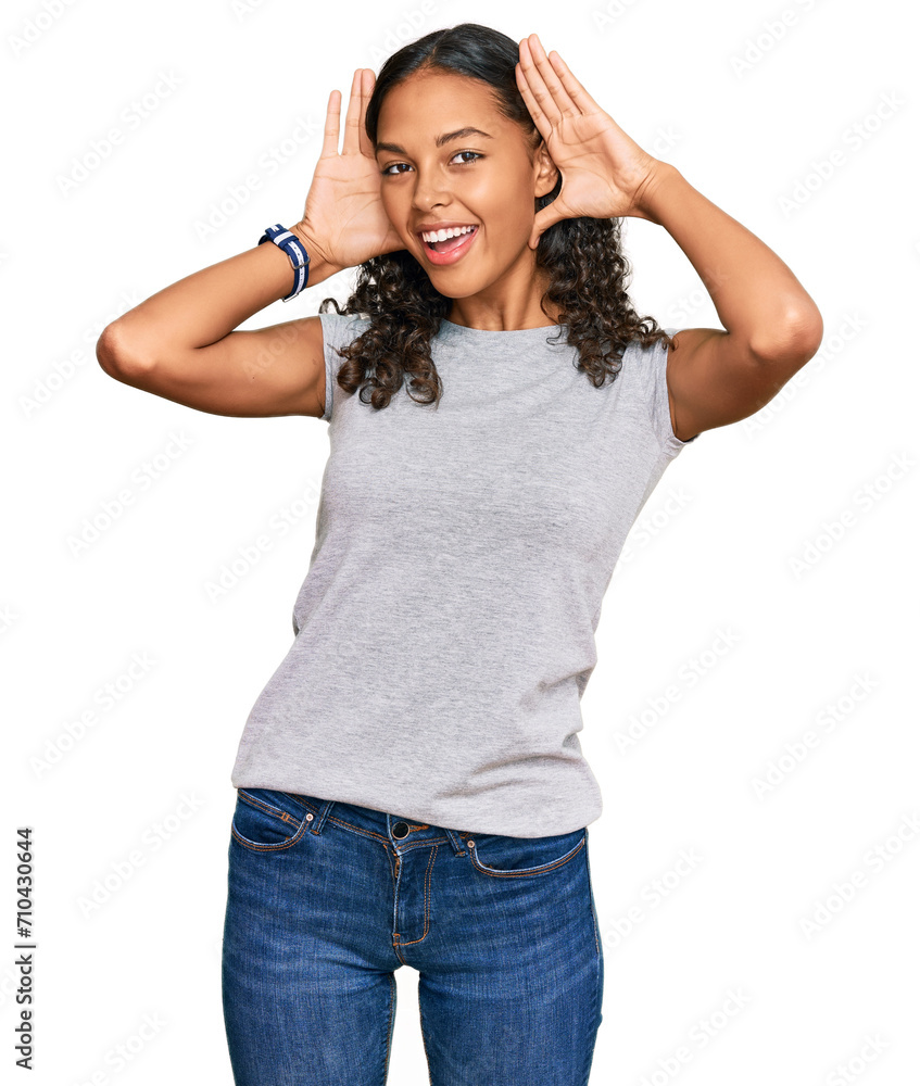Young african american girl wearing casual clothes smiling cheerful playing peek a boo with hands showing face. surprised and exited Young african american girl wearing casual clothes smiling cheerful playing peek a boo with hands showing face. surprised and exited