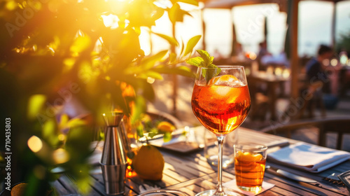 Aperol Spritz cocktail server on cafe patio  summer sunset