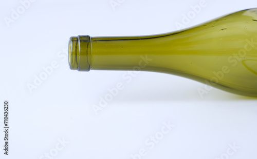 The neck of an empty bottle is on a white background. Green glass. Recycle. Copy space.
