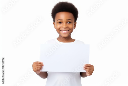 Happy black scholl boy holding blank white banner sign, isolated studio portrait. photo