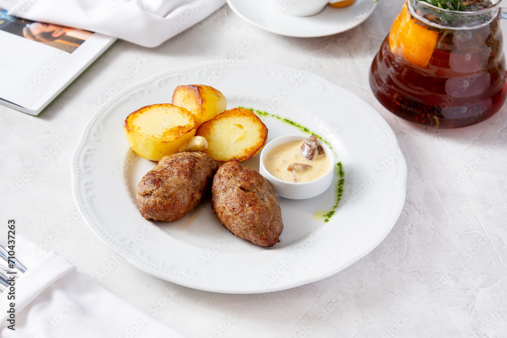 Homemade meat cutlets with baked potatoes Homemade meat cutlets with baked potatoes