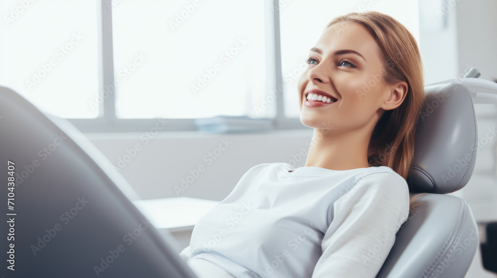 Happy young woman patient in clinic that is sitting and smiling Happy young woman patient in clinic that is sitting and smiling