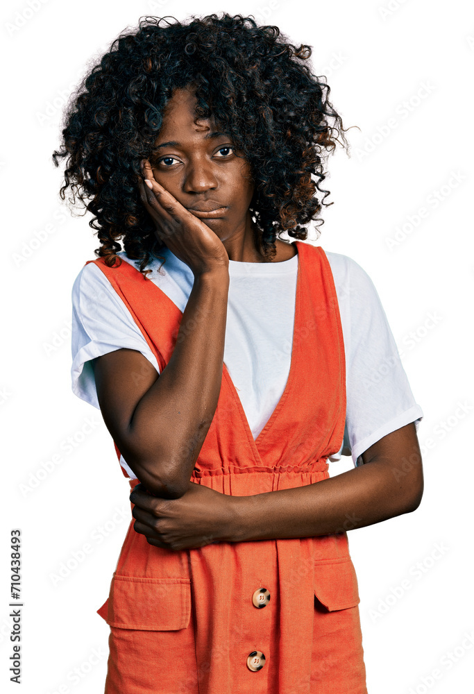 African woman with curly hair wearing casual white t shirt thinking looking tired and bored with depression problems with crossed arms. African woman with curly hair wearing casual white t shirt thinking looking tired and bored with depression problems with crossed arms.