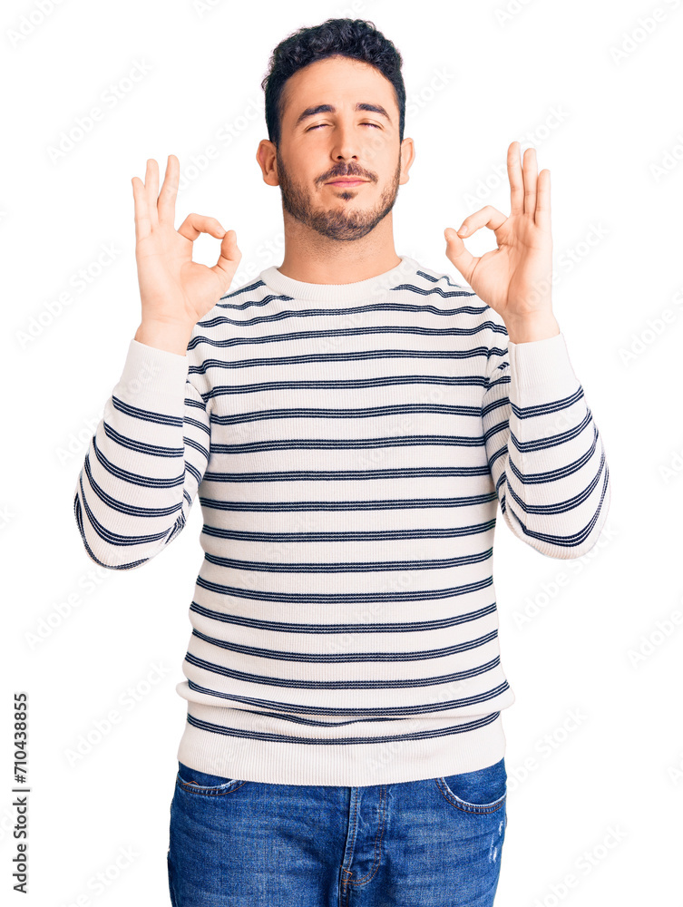 Young hispanic man wearing casual clothes relaxed and smiling with eyes closed doing meditation gesture with fingers. yoga concept. Young hispanic man wearing casual clothes relaxed and smiling with eyes closed doing meditation gesture with fingers. yoga concept.