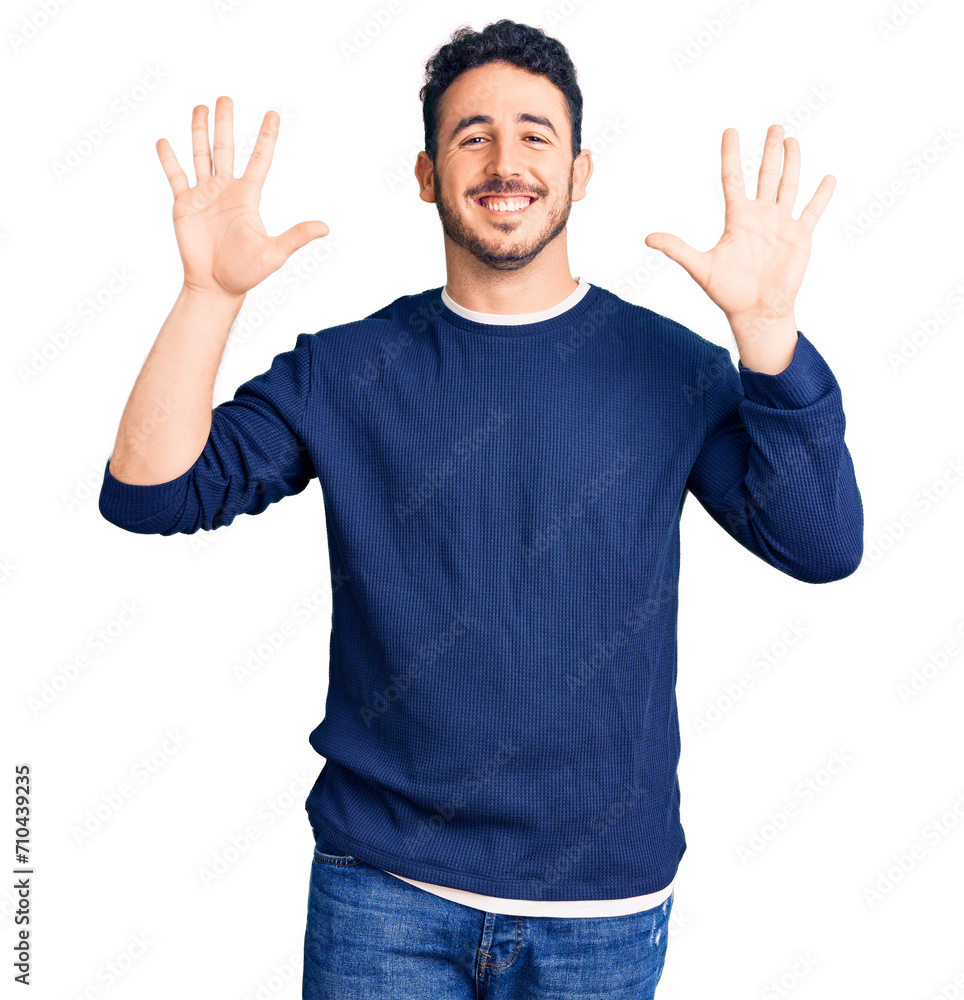 Young hispanic man wearing casual clothes showing and pointing up with fingers number ten while smiling confident and happy. Young hispanic man wearing casual clothes showing and pointing up with fingers number ten while smiling confident and happy.