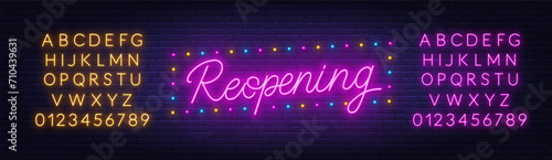 Reopening neon lettering on brick wall background