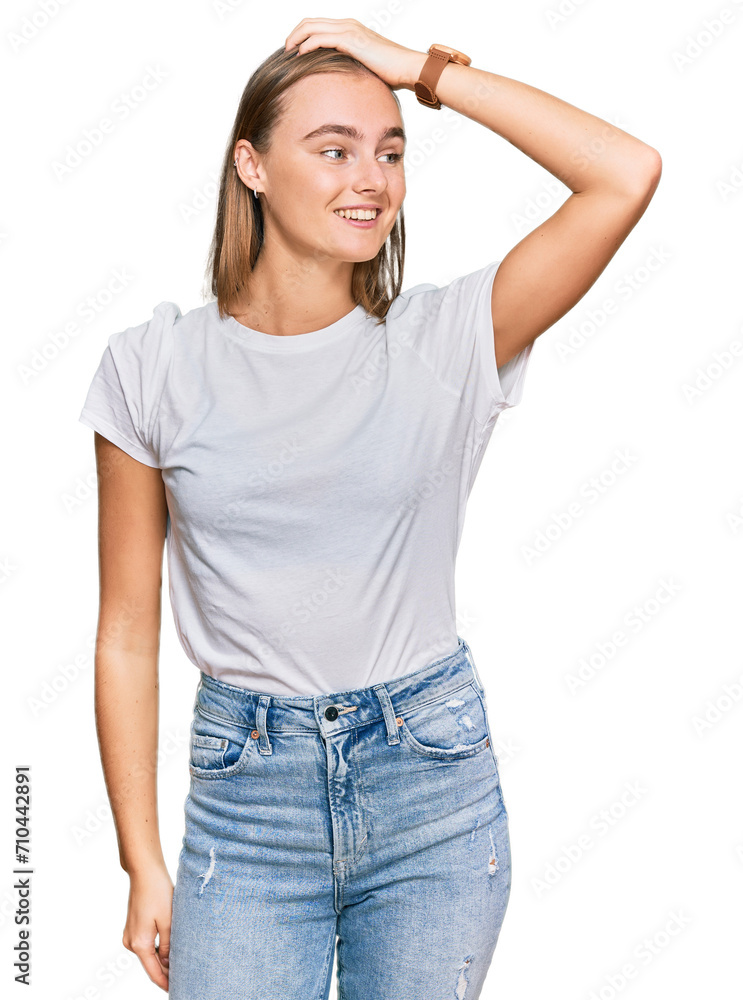 Beautiful young blonde woman wearing casual white t shirt smiling confident touching hair with hand up gesture, posing attractive and fashionable Beautiful young blonde woman wearing casual white t shirt smiling confident touching hair with hand up gesture, posing attractive and fashionable