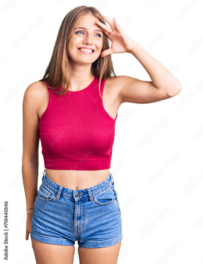 Young beautiful blonde woman wearing elegant summer shirt very happy and smiling looking far away with hand over head. searching concept. Young beautiful blonde woman wearing elegant summer shirt very happy and smiling looking far away with hand over head. searching concept.