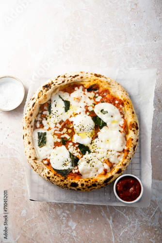 Traditional homemade pizza with tomato sauce and cheese photo