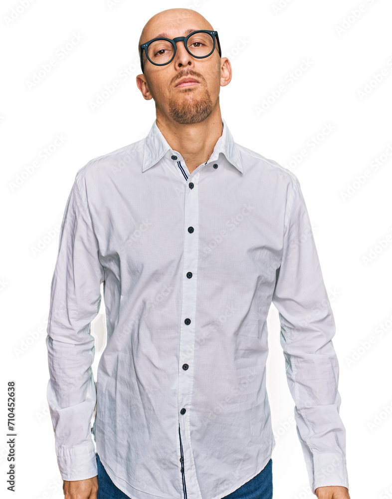 Bald man with beard wearing business shirt and glasses relaxed with serious expression on face. simple and natural looking at the camera. Bald man with beard wearing business shirt and glasses relaxed with serious expression on face. simple and natural looking at the camera.