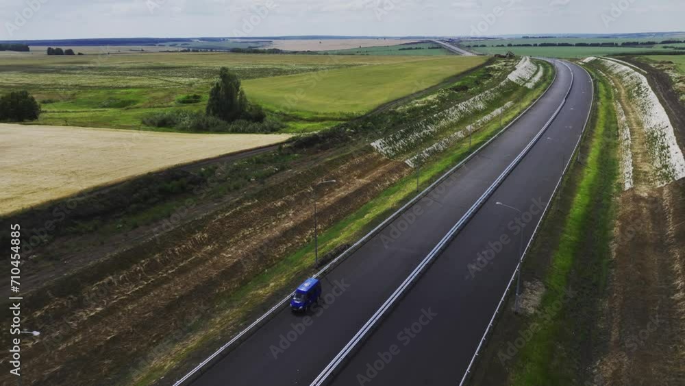 Expressway extends to horizon among green meadows. Strategically significant linking thoroughfare between major industrial metropolises Expressway extends to horizon among green meadows. Strategically significant linking thoroughfare between major industrial metropolises