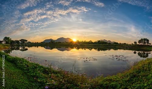 Fototapeta Naklejka Na Ścianę i Meble -  Tropical forest nature landscape with mountain range and pond water sunrise at Mae Moh mine, Lampang Thailand panorama