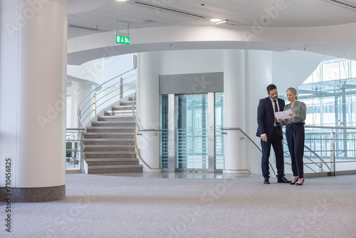 Businessman with Realtor looking at plans in new office space photo