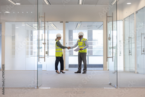Businessman shaking hands with relator in new office space photo