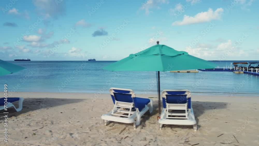 Close-up pan shot of beach chairs and umbrellas Close-up pan shot of beach chairs and umbrellas