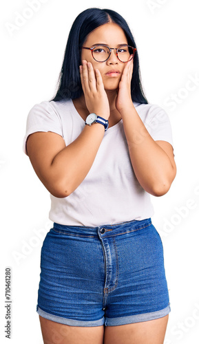 Young beautiful asian girl wearing casual clothes and glasses tired hands covering face, depression and sadness, upset and irritated for problem