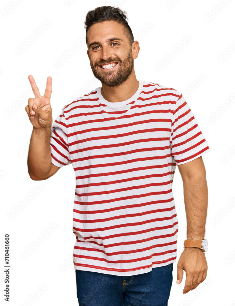 Handsome man with beard wearing striped tshirt smiling with happy face winking at the camera doing victory sign. number two. Handsome man with beard wearing striped tshirt smiling with happy face winking at the camera doing victory sign. number two.