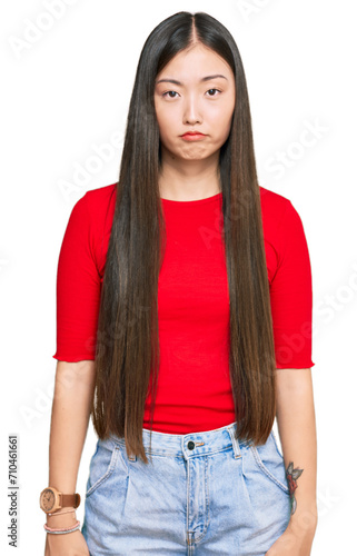 Young chinese woman wearing casual clothes depressed and worry for distress, crying angry and afraid. sad expression.