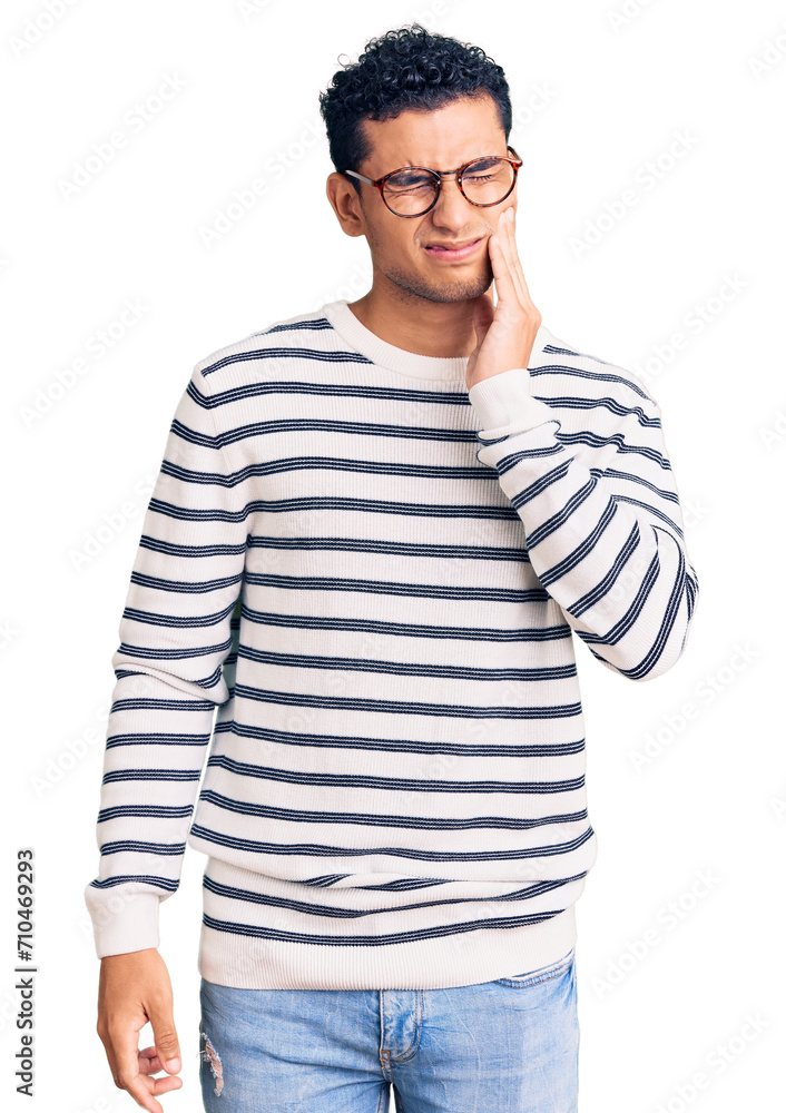 Hispanic handsome young man wearing casual clothes and glasses touching mouth with hand with painful expression because of toothache or dental illness on teeth. dentist Hispanic handsome young man wearing casual clothes and glasses touching mouth with hand with painful expression because of toothache or dental illness on teeth. dentist