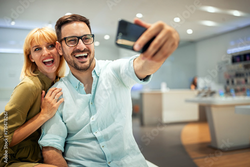 Couple is making selfie using a smart phone. Digital device  artificial intelligence concept.