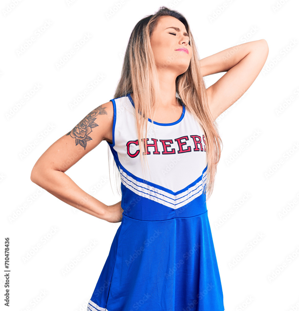 Young beautiful blonde woman wearing cheerleader uniform suffering of neck ache injury, touching neck with hand, muscular pain Young beautiful blonde woman wearing cheerleader uniform suffering of neck ache injury, touching neck with hand, muscular pain