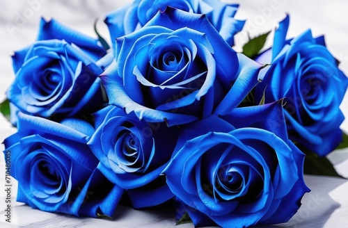 A bouquet of blue roses lies on a white marble table. Space for text  free space. A holiday card  a banner. March 8th  Valentine s Day.