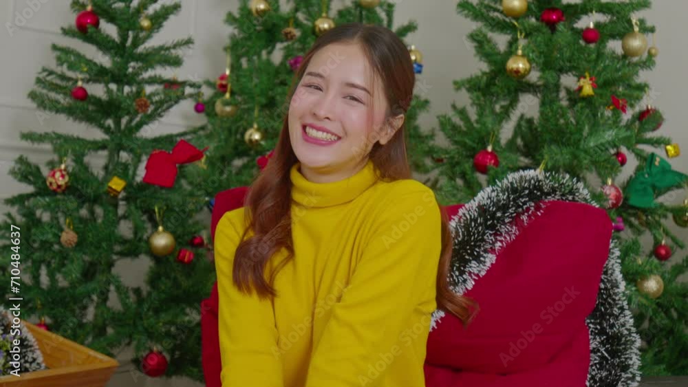 Asian beautiful woman radiates joy, smiling and celebrating the Christmas season at home, creating warm and festive moments filled with happiness and cheer. Asian beautiful woman radiates joy, smiling and celebrating the Christmas season at home, creating warm and festive moments filled with happiness and cheer.