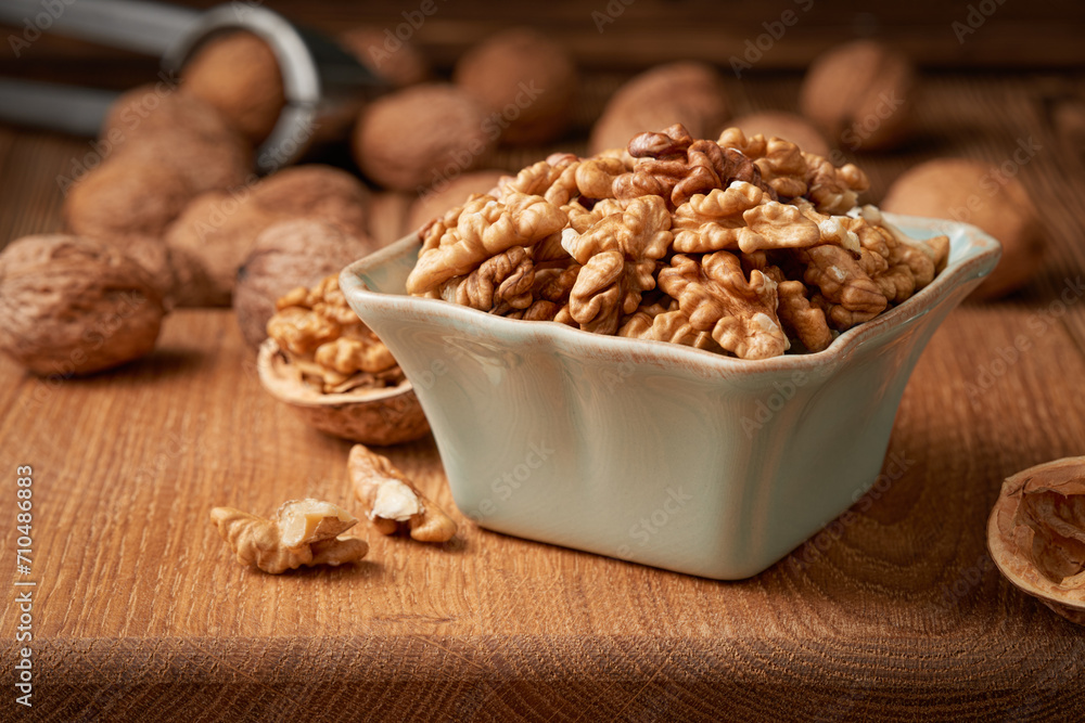 Close-up of a bowl of shelled walnut kernels. Low angle view. Close-up of a bowl of shelled walnut kernels. Low angle view.