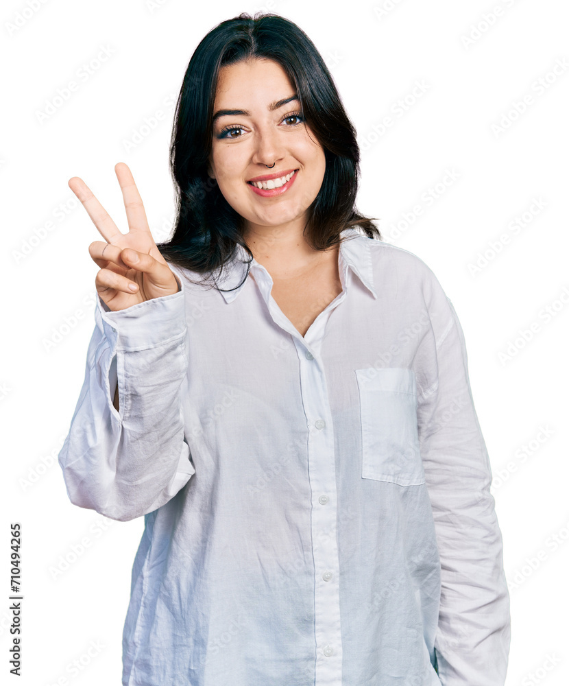 Beautiful hispanic woman wearing casual white shirt showing and pointing up with fingers number two while smiling confident and happy. Beautiful hispanic woman wearing casual white shirt showing and pointing up with fingers number two while smiling confident and happy.