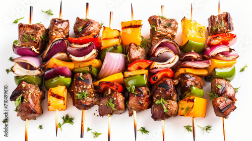 Metal skewers with delicious shish kebabs isolated on white background © Anas