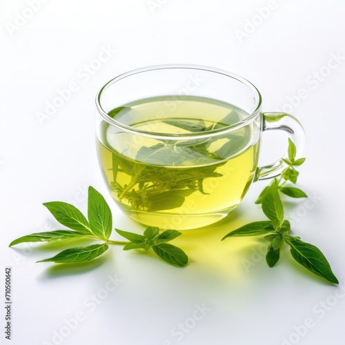 Green tea in glass cup with basil on white background