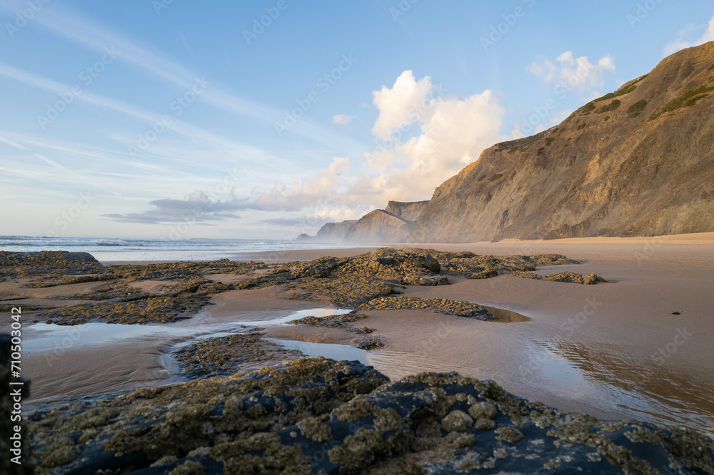 Cordoama beach in Portugal. Aerial drone view of waves, sandy beach and cliffs Cordoama beach in Portugal. Aerial drone view of waves, sandy beach and cliffs