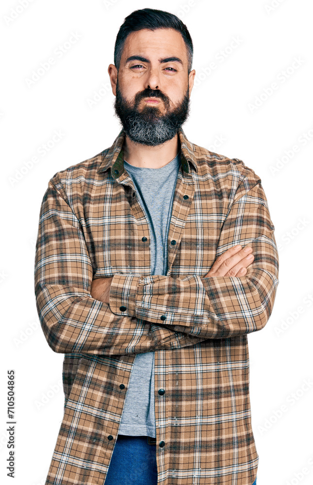 Hispanic man with beard with arms crossed gesture puffing cheeks with funny face. mouth inflated with air, catching air. Hispanic man with beard with arms crossed gesture puffing cheeks with funny face. mouth inflated with air, catching air.