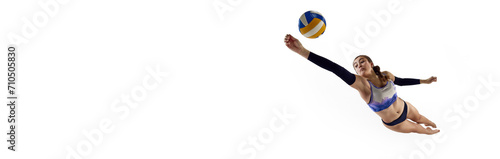 Concentrated and competitive young woman, beach volleyball player hitting ball in monition over white background. Concept of professional sport, competition, match. Banner. Empty space to insert text photo
