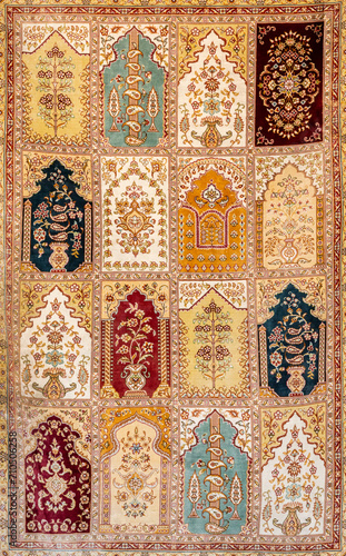Traditional Uzbekistan pattern on a colorful handmade silk carpet. Floral and geometrical elements, sand and ochre tones. Vertical. Bukhara (Boxoro), Uzbekistan