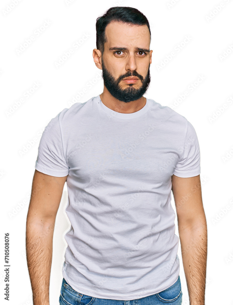 Fototapeta premium Young man with beard wearing casual white t shirt skeptic and nervous, frowning upset because of problem. negative person.