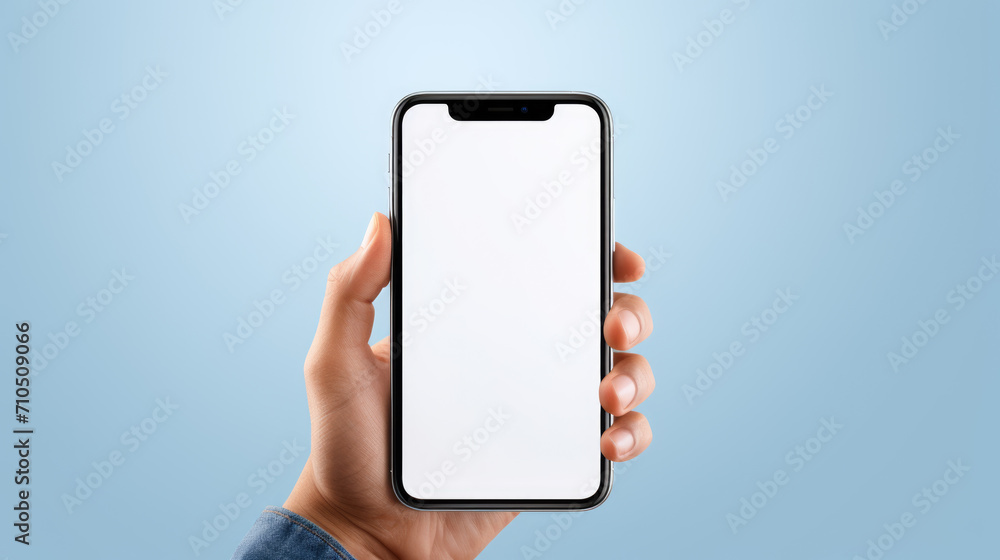 Hand holding a smartphone with a blank white screen against a blue background, offering a clear display for a mockup or app presentation. - obrazy, fototapety, plakaty 