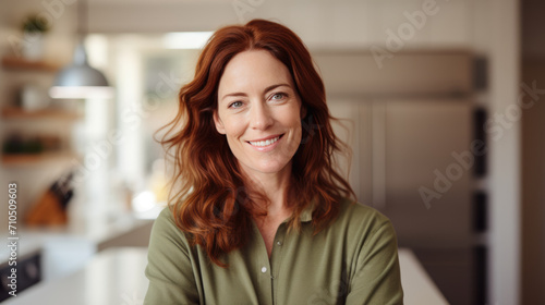 Woman with red hair and a warm smile,