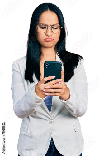 Beautiful hispanic woman with nose piercing using smartphone typing message depressed and worry for distress, crying angry and afraid. sad expression.