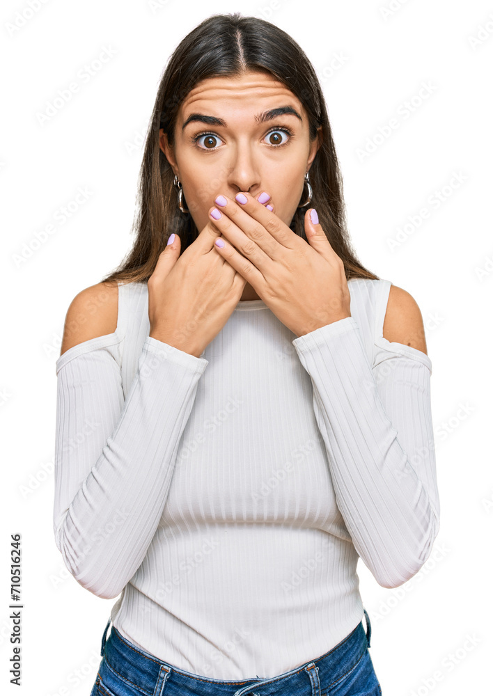 Young hispanic woman wearing casual clothes shocked covering mouth with hands for mistake. secret concept. Young hispanic woman wearing casual clothes shocked covering mouth with hands for mistake. secret concept.