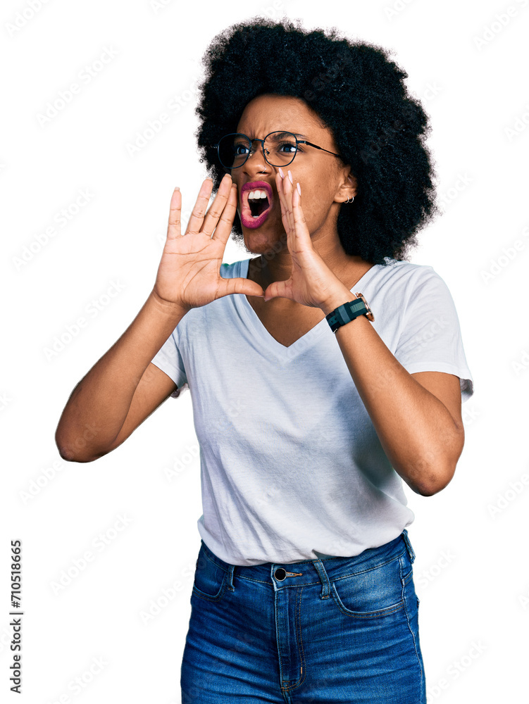 Young african american woman wearing casual white t shirt shouting angry out loud with hands over mouth Young african american woman wearing casual white t shirt shouting angry out loud with hands over mouth